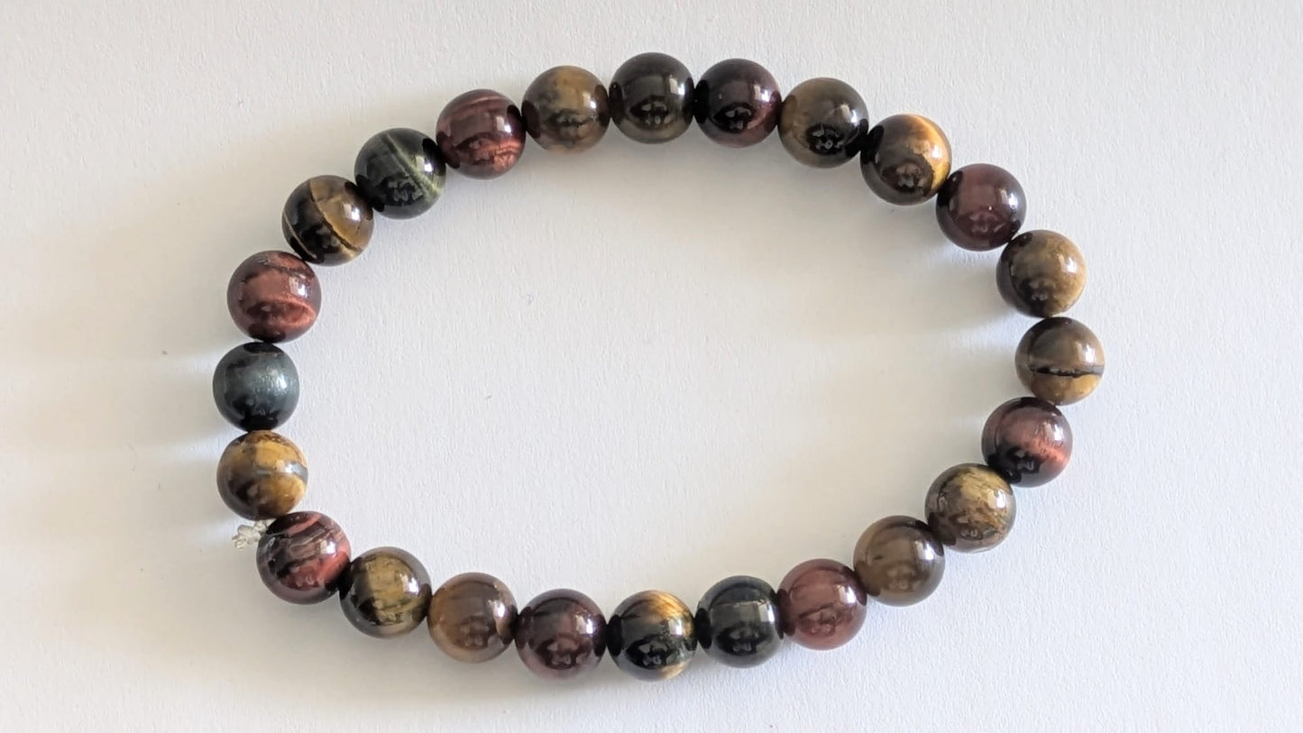 BRACELET EN ŒIL MIXTE (TIGRE • FAUCON • TAUREAU) – Perles 8 mm – Artisanat de Madagascar Pierre d’harmonie, protection & énergie équilibrée | Reflets dorés, bleutés et rouges | Bracelet élastique fait main