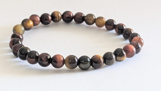 BRACELET EN ŒIL MIXTE (TIGRE • FAUCON • TAUREAU) – Perles 8 mm – Artisanat de Madagascar Pierre d’harmonie, protection & énergie équilibrée | Reflets dorés, bleutés et rouges | Bracelet élastique fait main